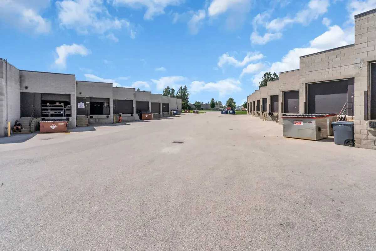 The shared loading dock lane behind the Prep Buddies unit in London, Ontario, with roll-up dock doors on both sides