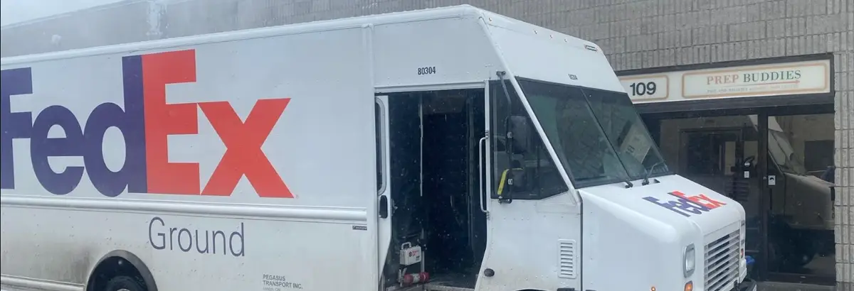 FedEx Ground truck loading at the Prep Buddies warehouse entrance