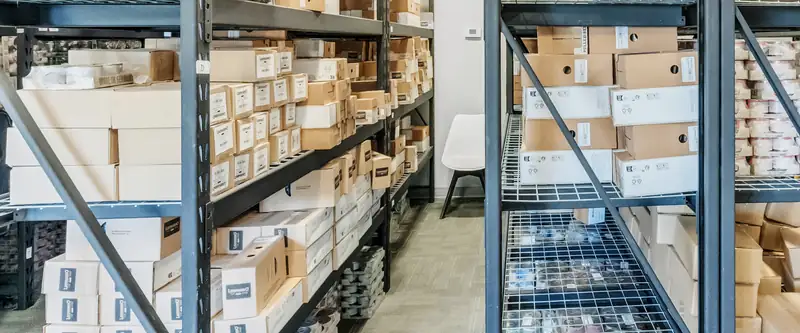 Wire shelving in the stock room holding boxed goods and stacked cans
