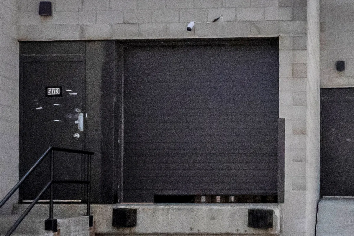 The entry door numbered 573 and the roll-up dock door of the Prep Buddies unit